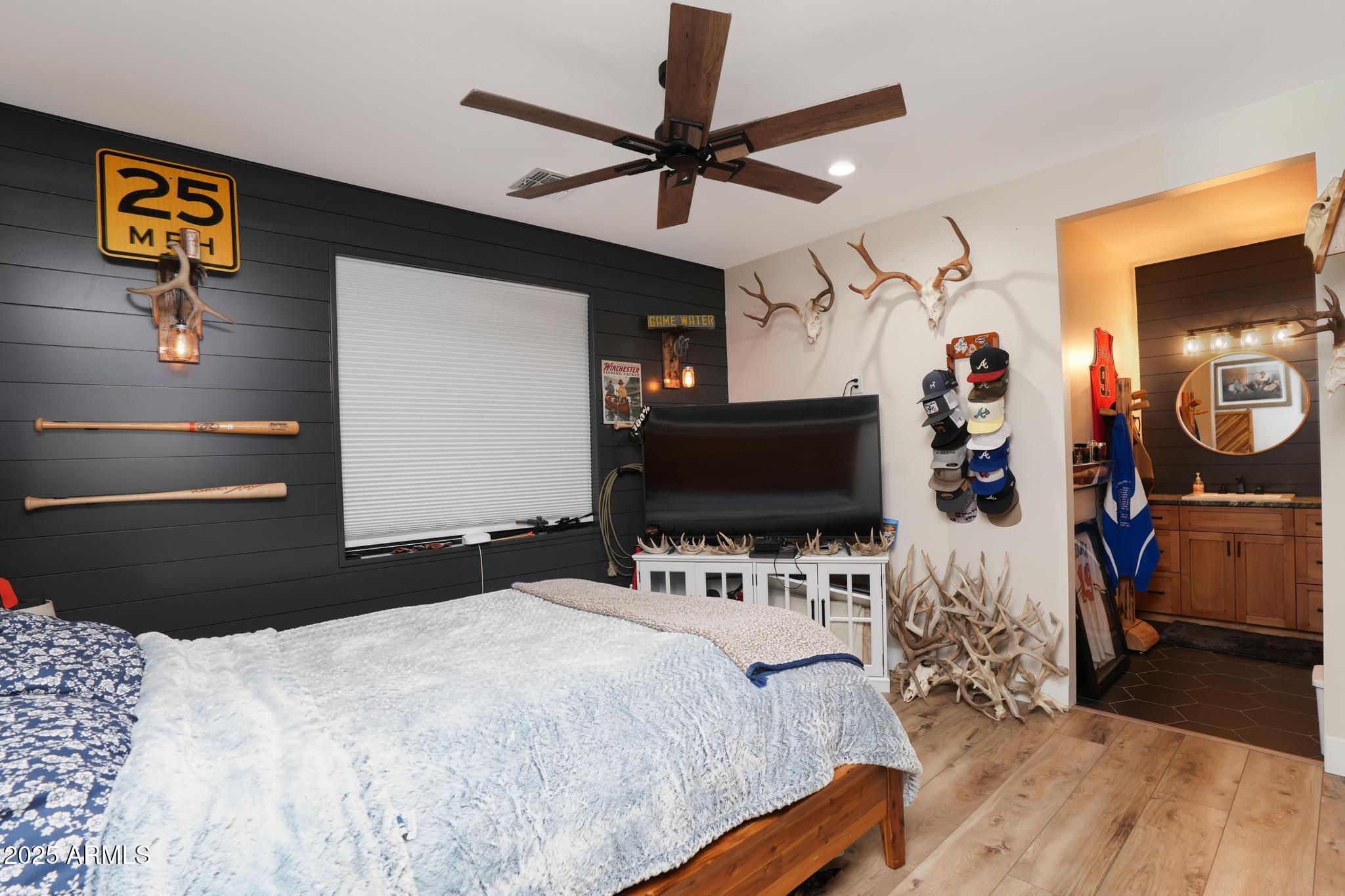 2900 West Spring View Drive Cottonwood, AZ 86326 - Photo 23 of 68 a bedroom with a bed and a flat tv screen on wall