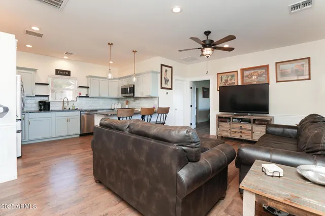 a view of a deck with a table and chairs with wooden floor and fence