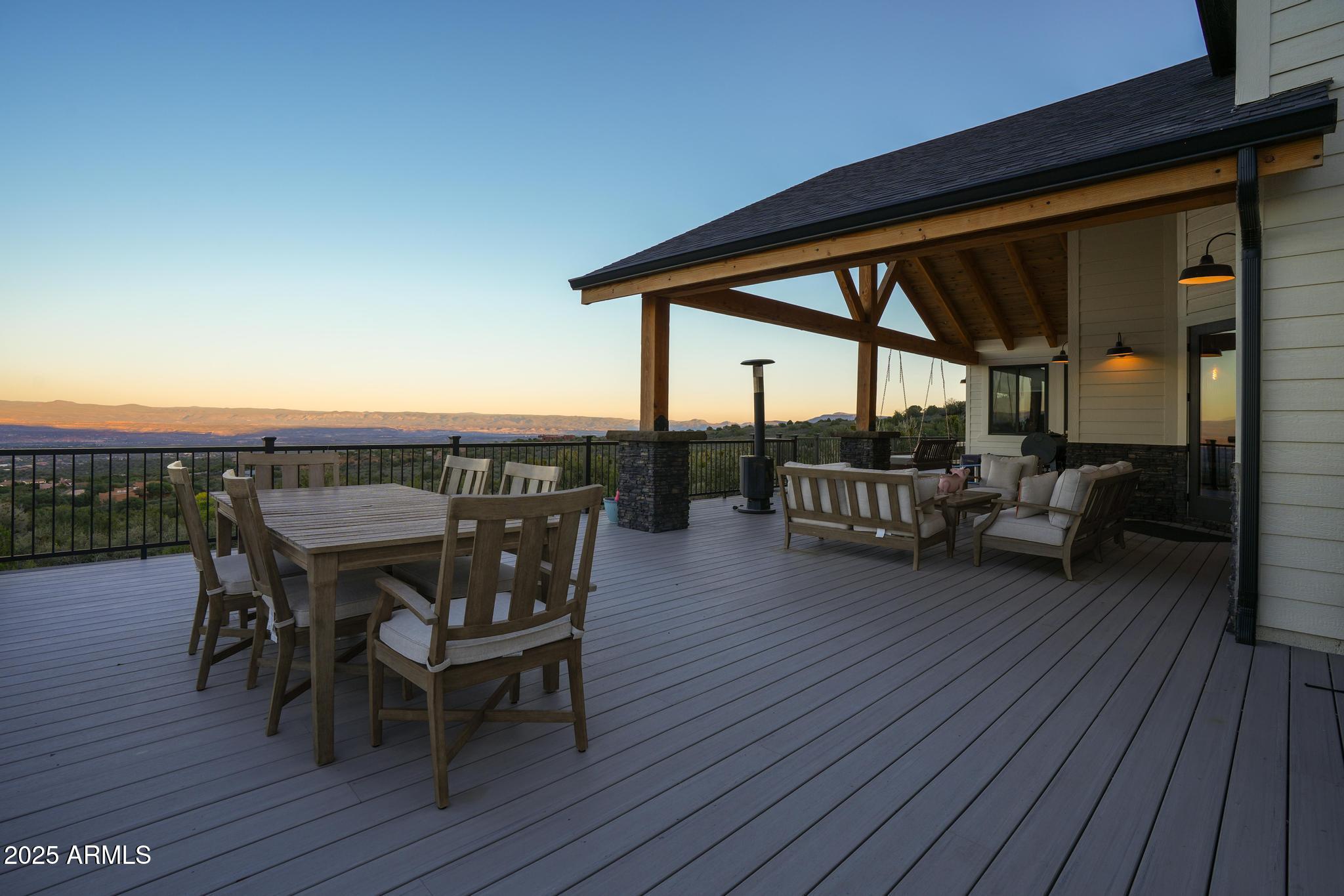 2900 West Spring View Drive Cottonwood, AZ 86326 - Photo 57 of 68 a view of a roof deck with table and chairs a barbeque with wooden floor and fence