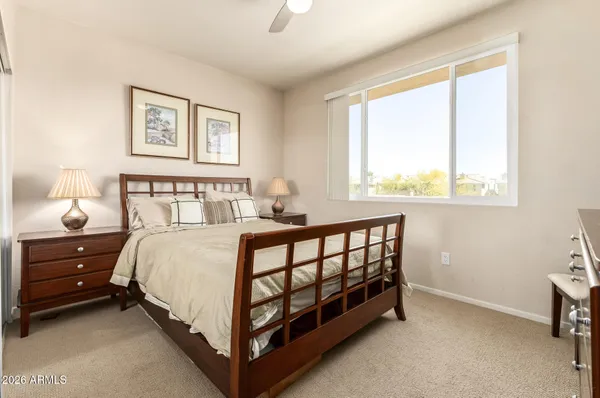 a large bedroom with a bed and flat screen tv