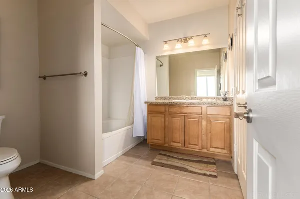 a bedroom with a large bed tv and a window