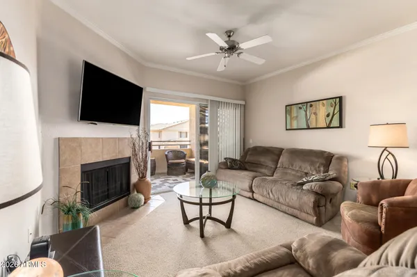a living room with furniture a flat screen tv and a fireplace