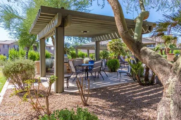 a view of a patio with a table and chairs and potted plants