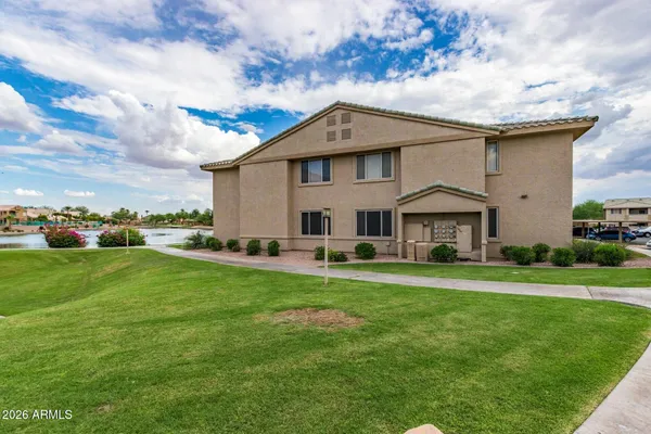 a view of a lake with houses in the back