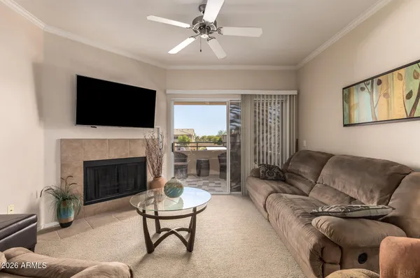 a living room with furniture a rug and white wall