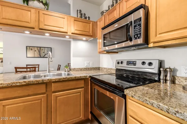 a kitchen with stainless steel appliances granite countertop a stove and a sink