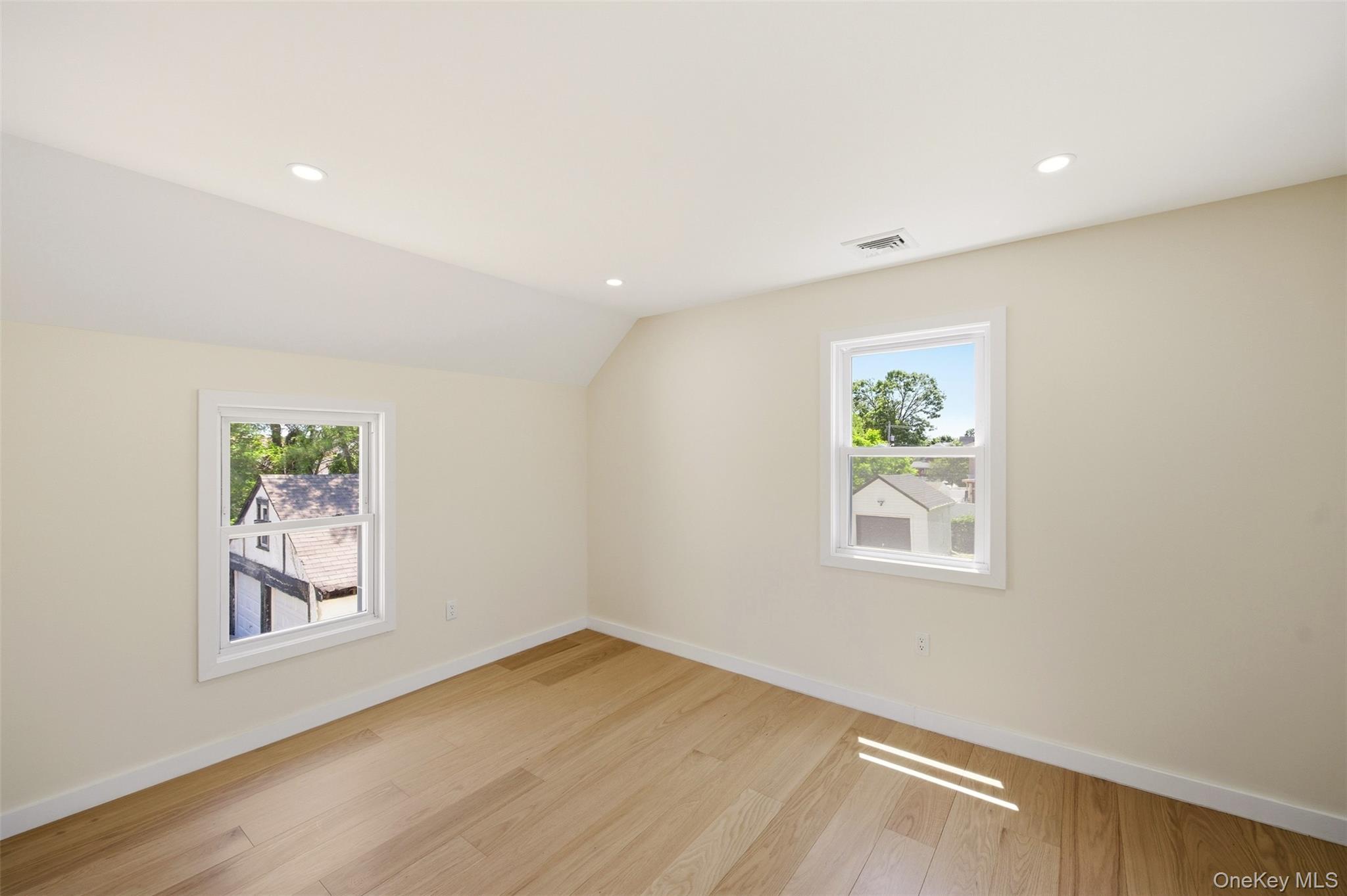 135 Whaley Street Freeport, NY 11520 - Photo 28 of 38 wooden floor in an empty room with a window