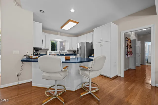 a living room with furniture a dining table and kitchen view