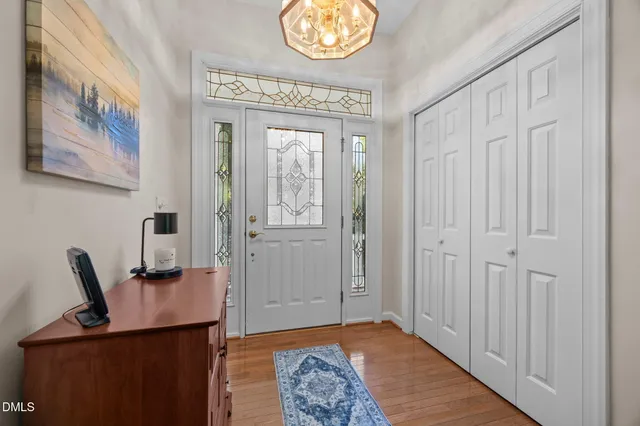 a view of a hallway with workspace and a window