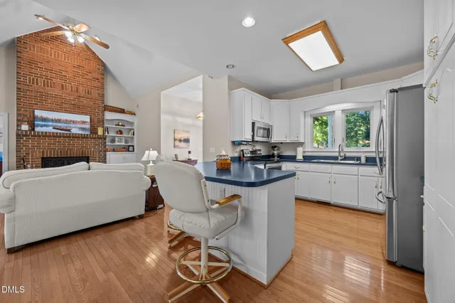 a kitchen with sink cabinets and wooden floor