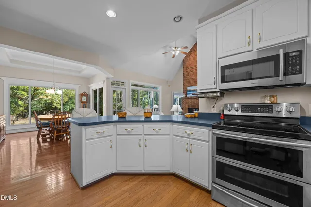 a kitchen with stainless steel appliances a stove microwave and cabinets