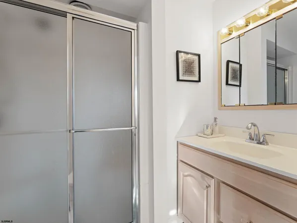 a bedroom with a bed and a dresser next to a window