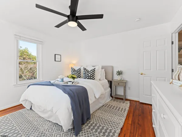 a bedroom with a bed and ceiling fan