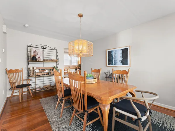 a kitchen with a stove a sink a dining table and chairs
