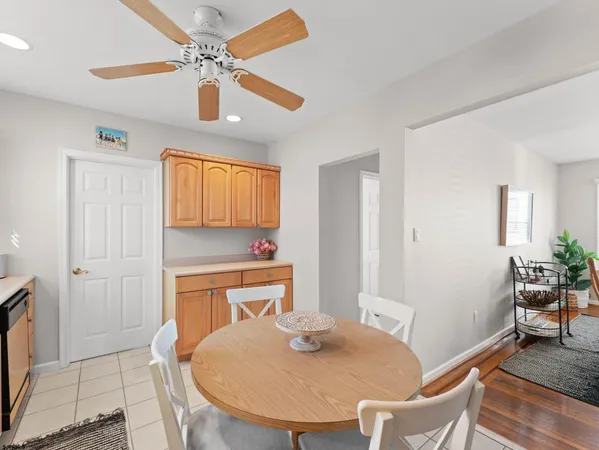 a kitchen with a stove a sink a dining table and chairs
