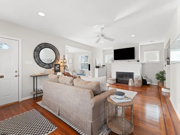 a living room with furniture and a wooden floor