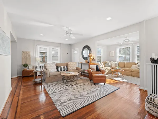 a living room with furniture a large window and a table
