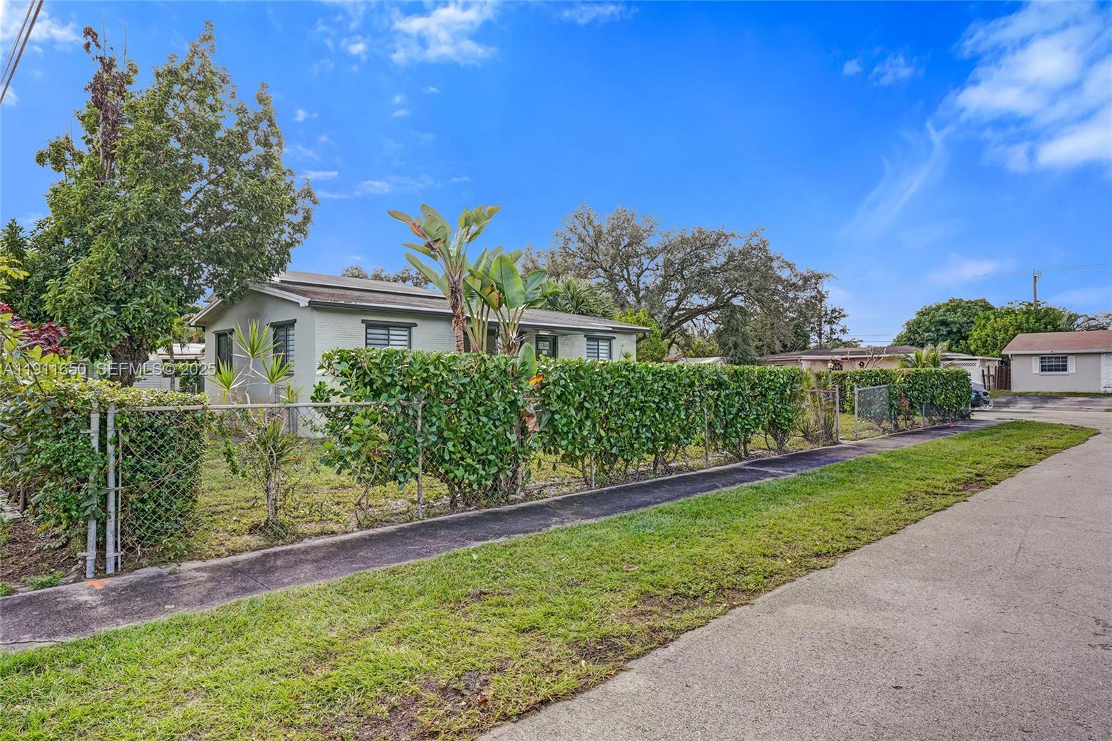 6470 McClellan Street Hollywood, FL 33024 - Photo 19 of 74 a view of a house with a yard
