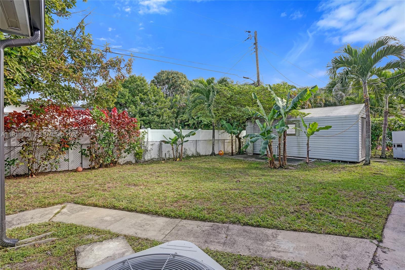 6470 McClellan Street Hollywood, FL 33024 - Photo 32 of 74 a backyard of a house with lots of green space