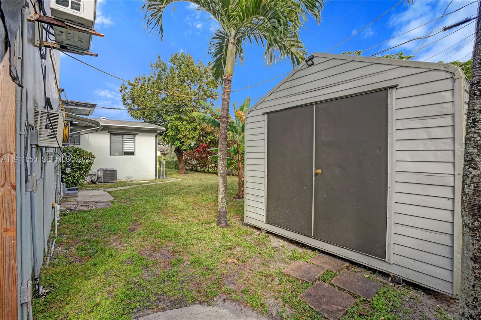 6470 McClellan Street Hollywood, FL 33024 - Photo 37 of 74 a view of house with backyard and garden