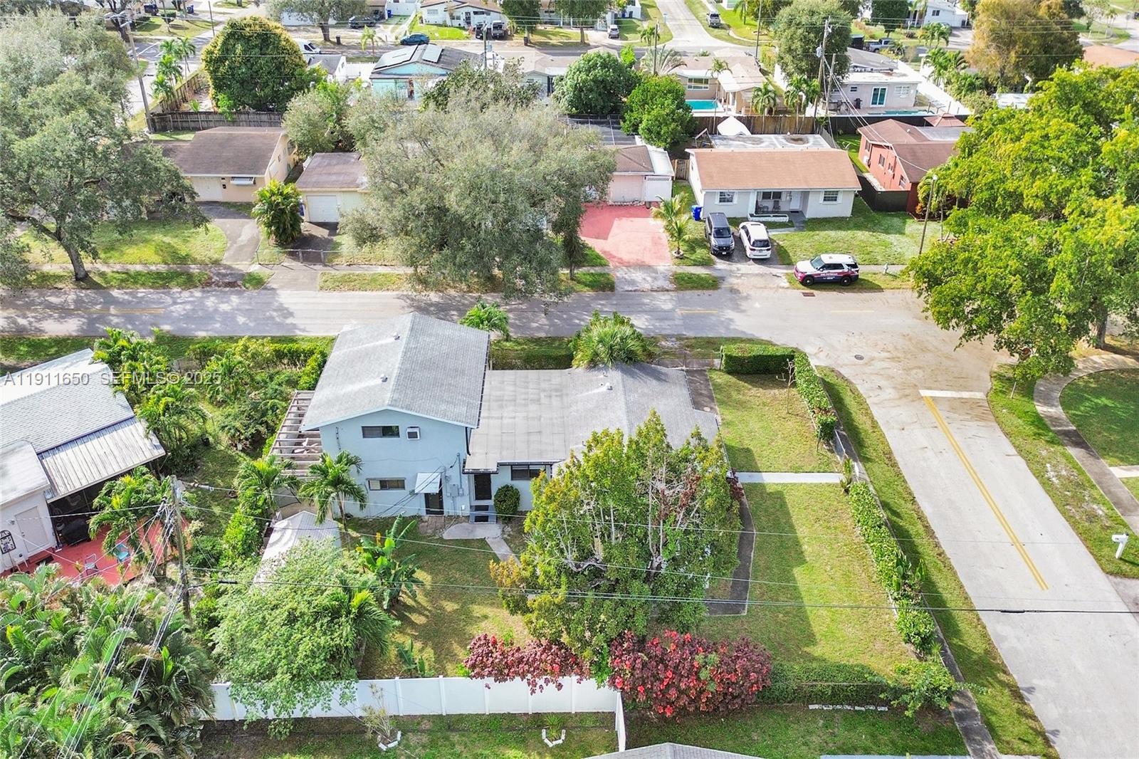 6470 McClellan Street Hollywood, FL 33024 - Photo 8 of 74 an aerial view of a house with a garden and lake view
