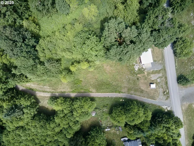 a backyard of a house with a yard and outdoor seating