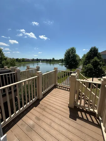 a view of balcony with wooden floor and lake view