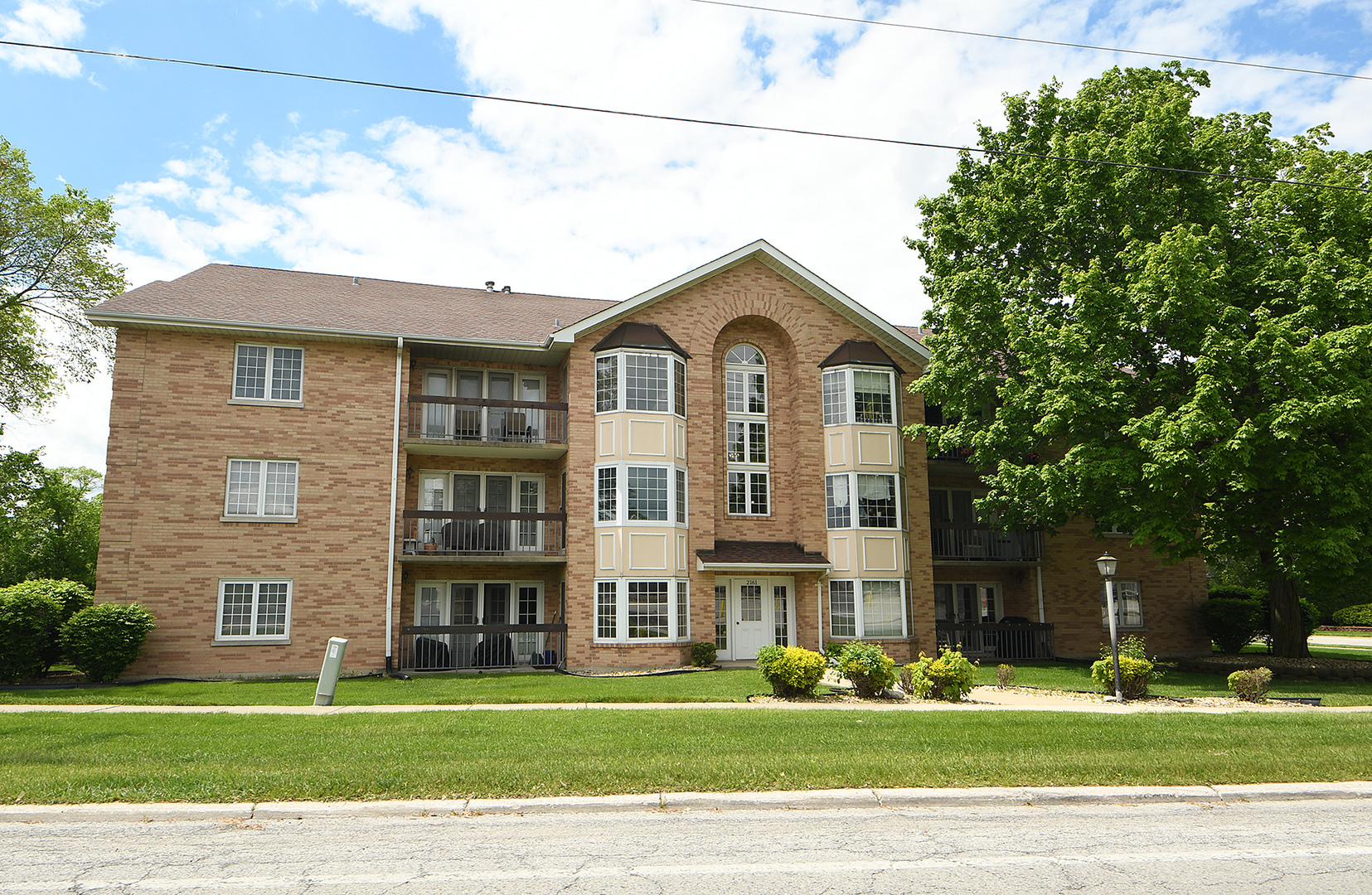 2161 Oak Road, Unit 3A Homewood, IL 60430 - Photo 1 of 20 a front view of a house with a garden and trees