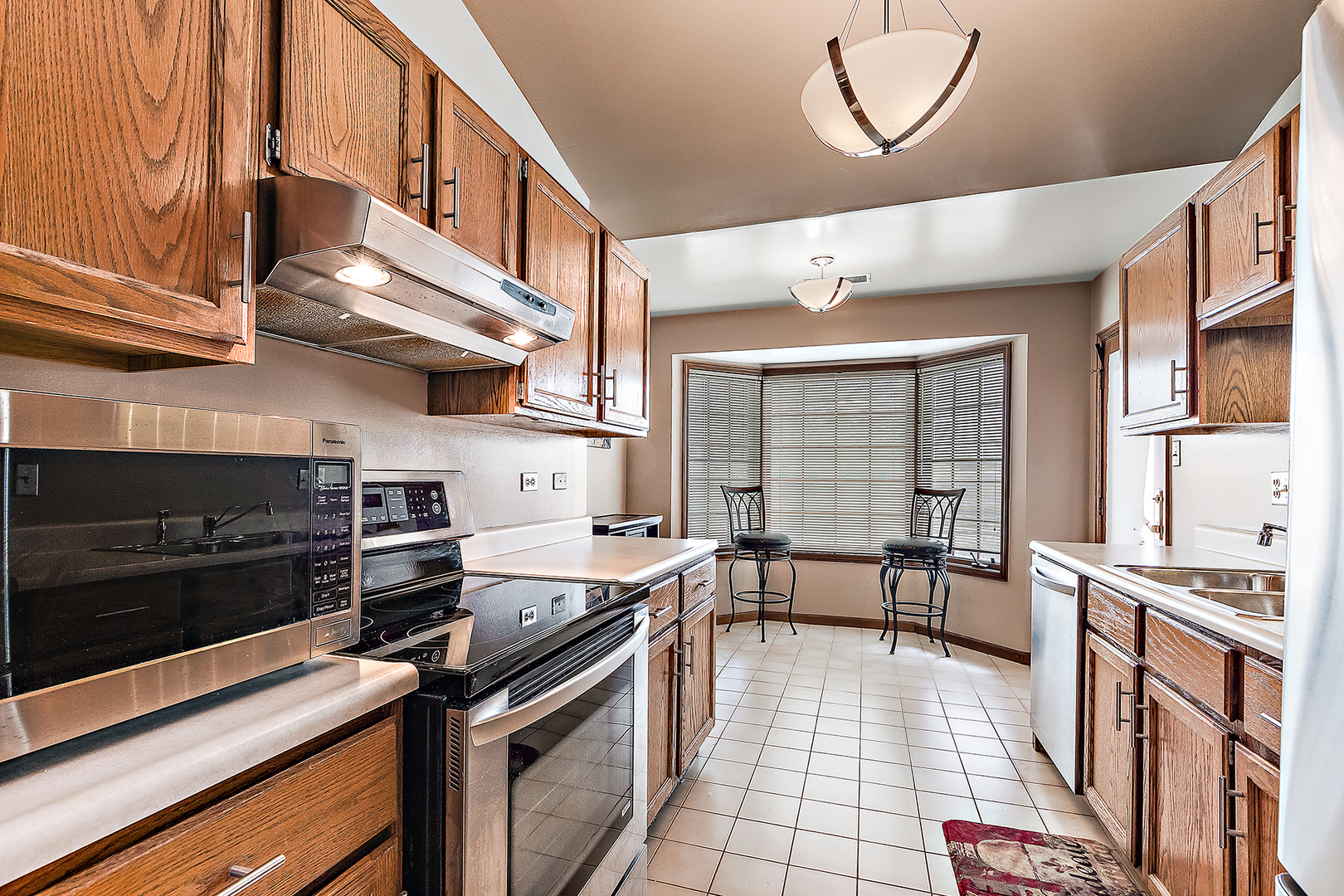 2161 Oak Road, Unit 3A Homewood, IL 60430 - Photo 11 of 20 a kitchen with stainless steel appliances granite countertop a stove a sink and a microwave
