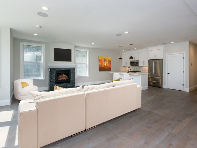 a living room with furniture a fireplace and a television