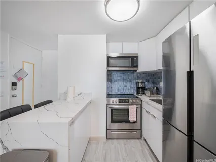 a kitchen with a stove a sink and a refrigerator