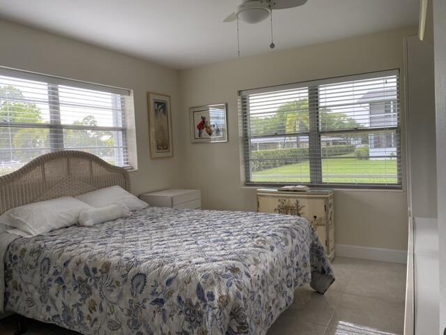 321 Durham, Unit 321 Deerfield Beach, FL 33442 - Photo 5 of 18 a bedroom with a large bed and a large window