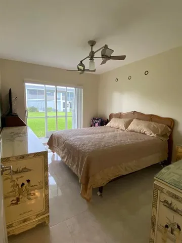 a bedroom with a bed and ceiling chandelier