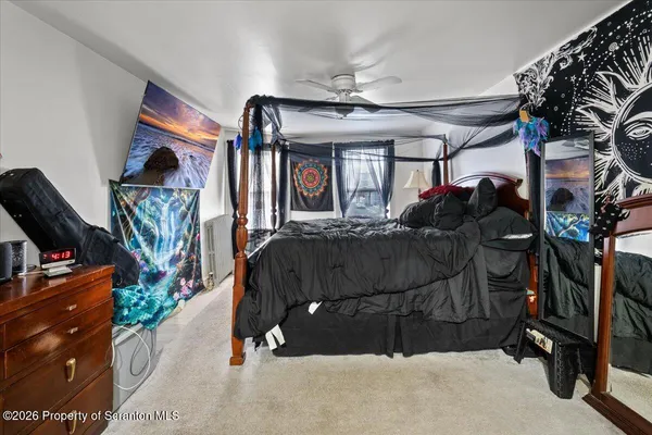 a bedroom with a bed and flat screen tv
