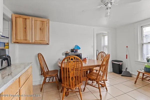 a kitchen with stainless steel appliances a sink a stove a table and chairs