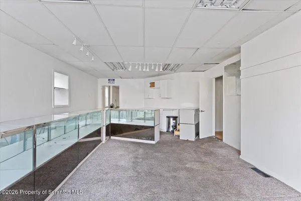 a view of a room with wooden floor and staircase