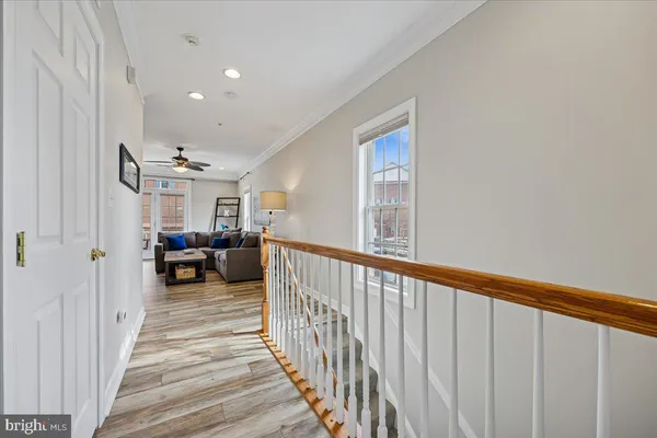 a view of a hallway with a livingroom and entryway