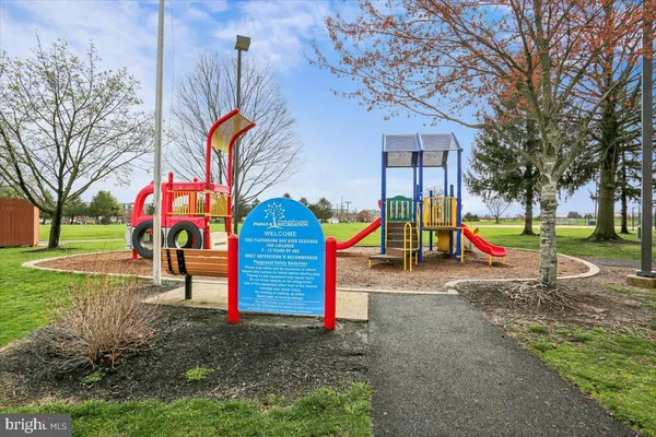 a view of a swimming pool with a yard and sitting area