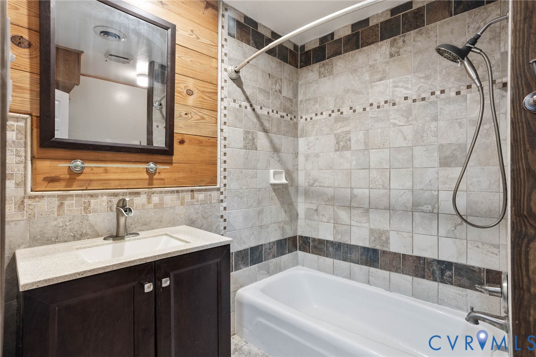3843 Quinton Road Quinton, VA 23141 - Photo 16 of 26 a bathroom with a sink vanity granite shower and a mirror