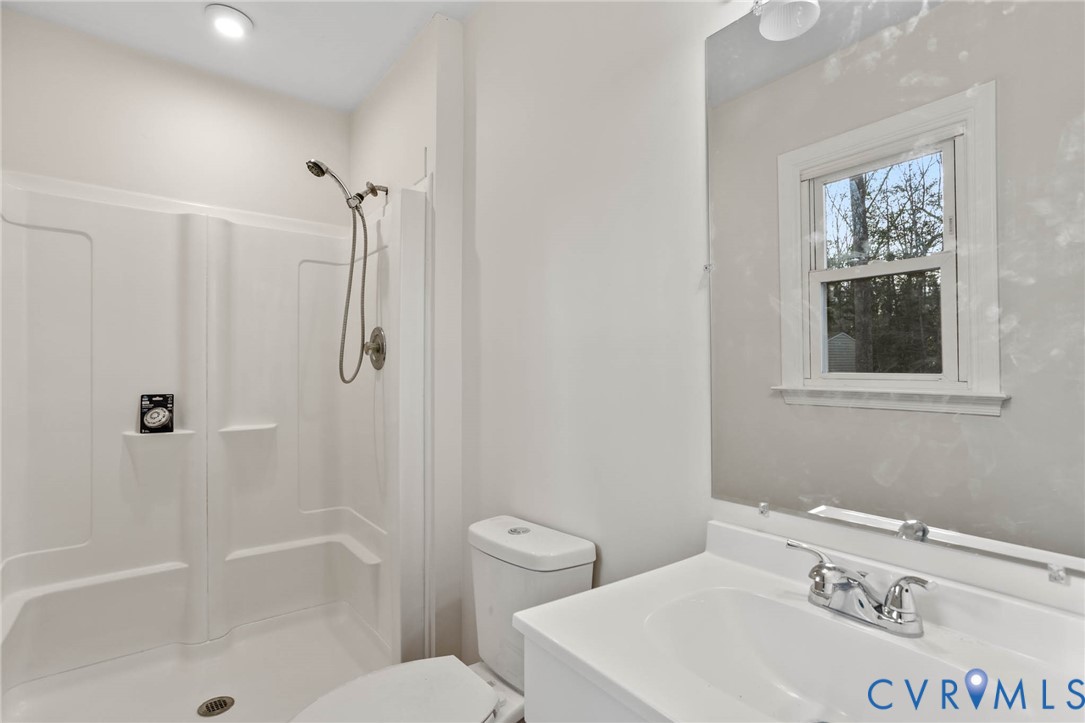 3843 Quinton Road Quinton, VA 23141 - Photo 19 of 26 a bathroom with a sink a toilet and shower