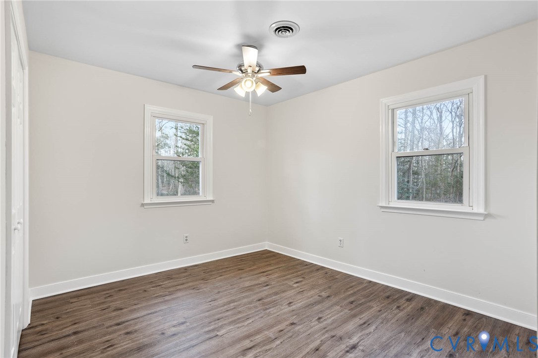 3843 Quinton Road Quinton, VA 23141 - Photo 20 of 26 a view of an empty room with wooden floor and a window