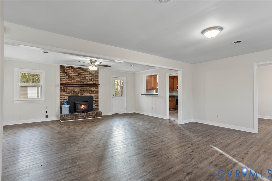 3843 Quinton Road Quinton, VA 23141 - Photo 5 of 26 an empty room with wooden floor and fireplace