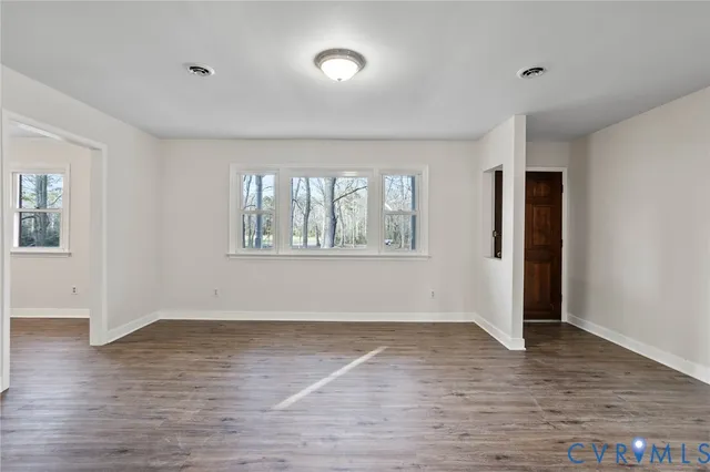 wooden floor in an empty room with a window