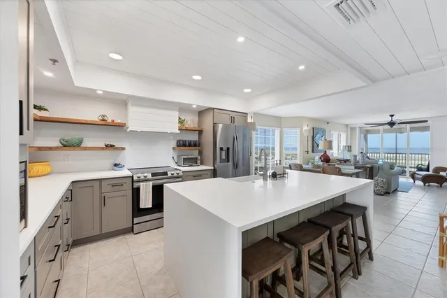 a room with a white table chairs and white walls