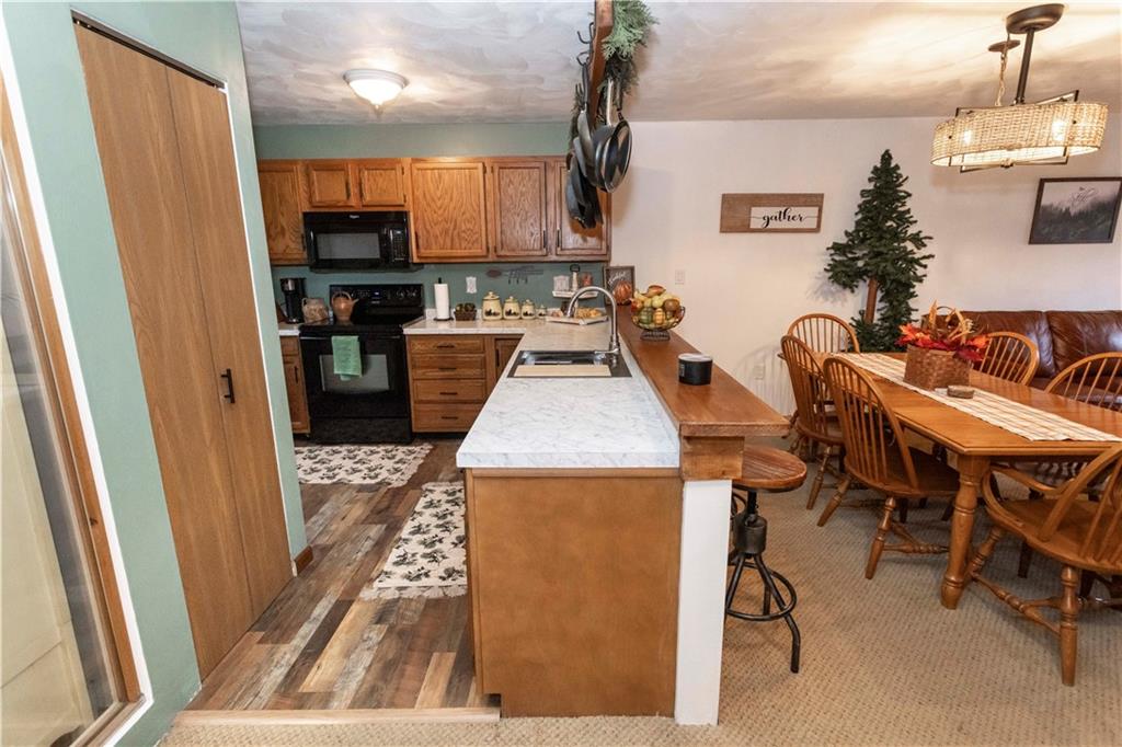 1817 Eagles Ridge Court Hidden Valley, PA 15502 - Photo 16 of 50 a kitchen with a table chairs refrigerator and microwave