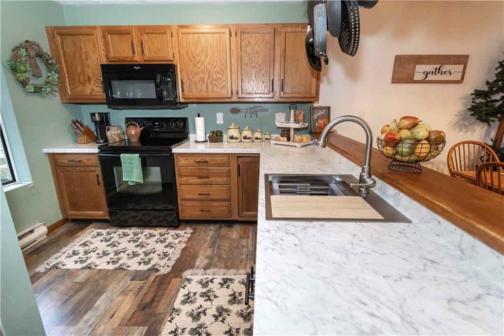 1817 Eagles Ridge Court Hidden Valley, PA 15502 - Photo 17 of 50 a kitchen with stainless steel appliances granite countertop a stove a sink and a microwave