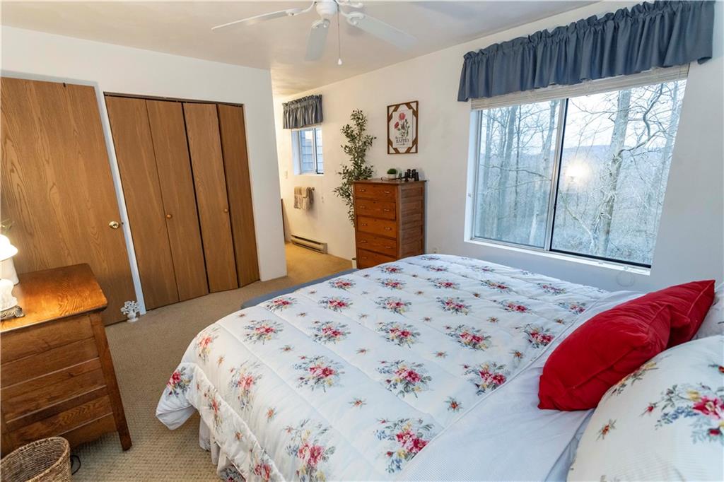 1817 Eagles Ridge Court Hidden Valley, PA 15502 - Photo 25 of 50 a bedroom with a bed and a dresser next to a window