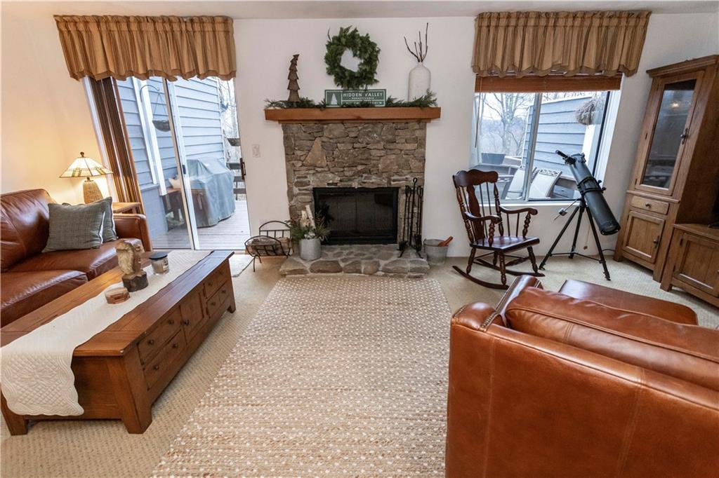 1817 Eagles Ridge Court Hidden Valley, PA 15502 - Photo 9 of 50 a living room with furniture a fireplace and a large window