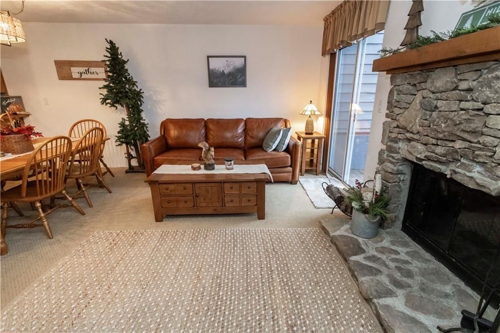 1817 Eagles Ridge Court Hidden Valley, PA 15502 - Photo 10 of 50 a living room with furniture a flat screen tv and a fireplace