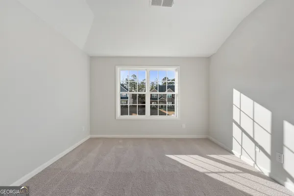 a view of an empty room with a ceiling fan